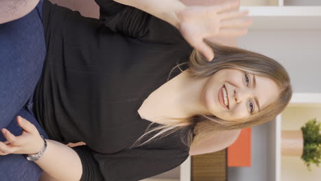 Vertical-video-of-The-woman-waving-at-the-camera.